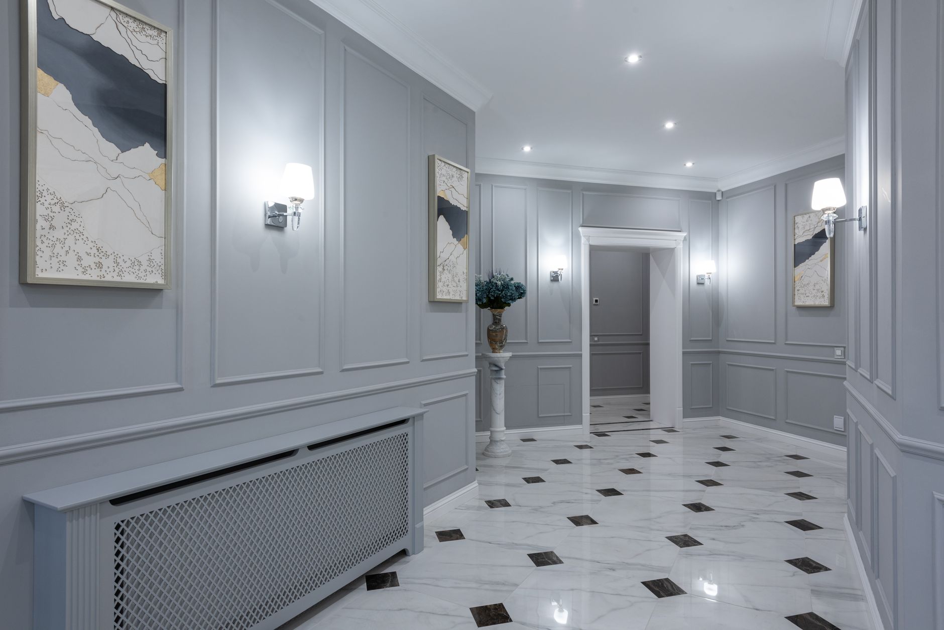 A hallway with gray walls and a tiled floor