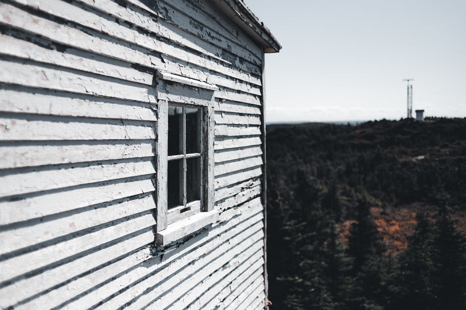 Painted house wall with a window and trim